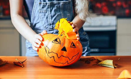 Person carving a pumpkin